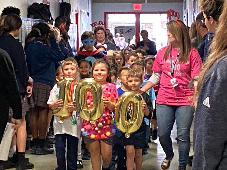 Riverside Academys elementary students and teachers marked the 100th day of school with costumes and a walk-through of the high school. 