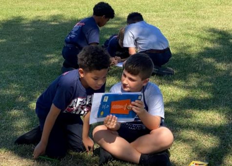 RAs Book Buddies Program pairs third through fifth graders with kindergarten through second graders for read alouds and other ELA activities. 