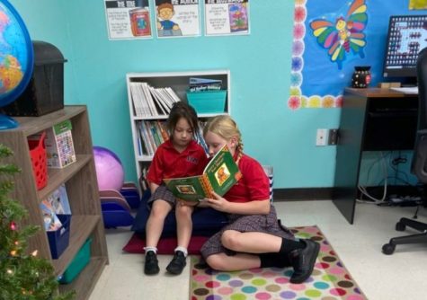 Book Buddies Lucy Stowe and Ragen Fuergeson share a book . 