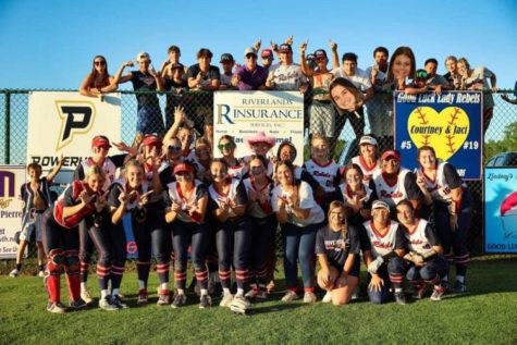 The Lady Rebels celebrated Saturdays win with their fence fans. 