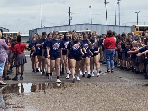 The Riverside softball team made its way through cheering students and teachers to board the bus for Sulphur. 