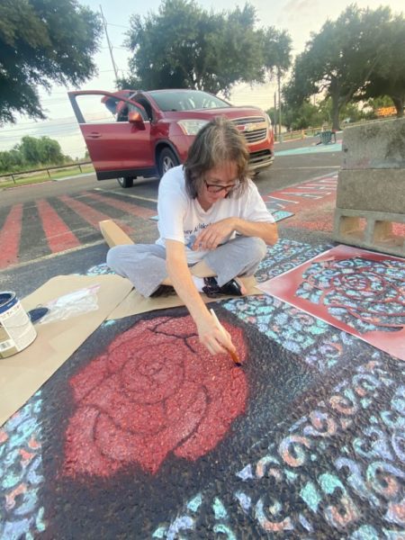 Lisa Weiler helps her daughter Jessie paint a rose in Jessies senior parking spot. 