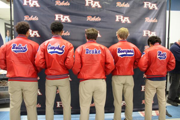 Riverside Academy football players show off their names on the backs of their new letter jackets Friday. 