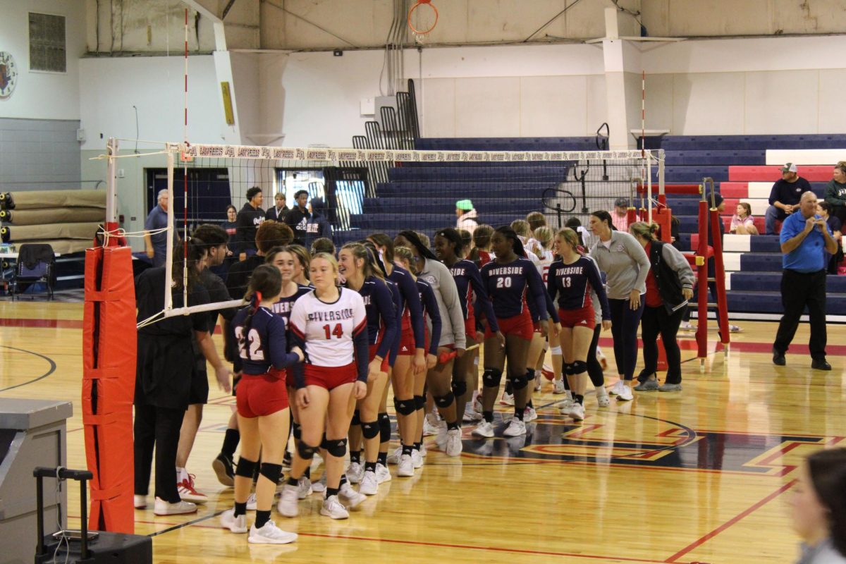 The Lady Rebels slap hands with Sacred Heart players on Wednesday, Oct. 30.