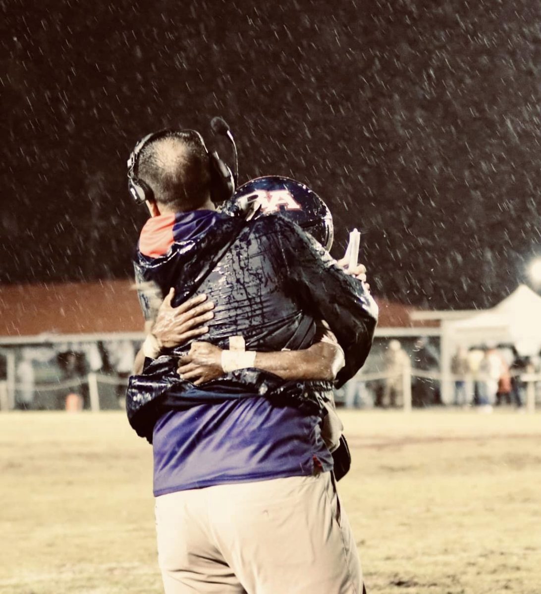 Coach Lee Roussel celebrates the win with a player. 