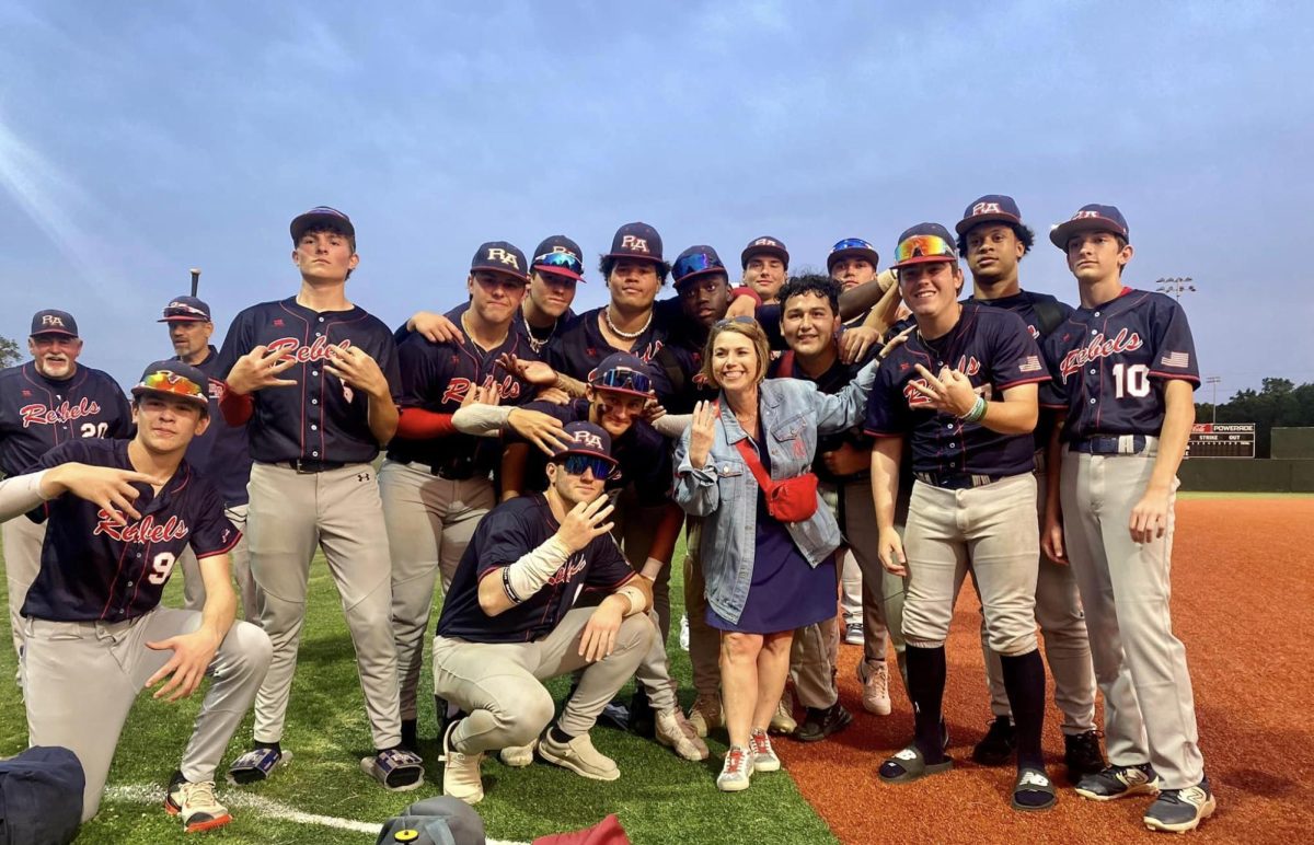The Riverside Academy baseball team celebrated its regional victory with principal Holly Haase. 