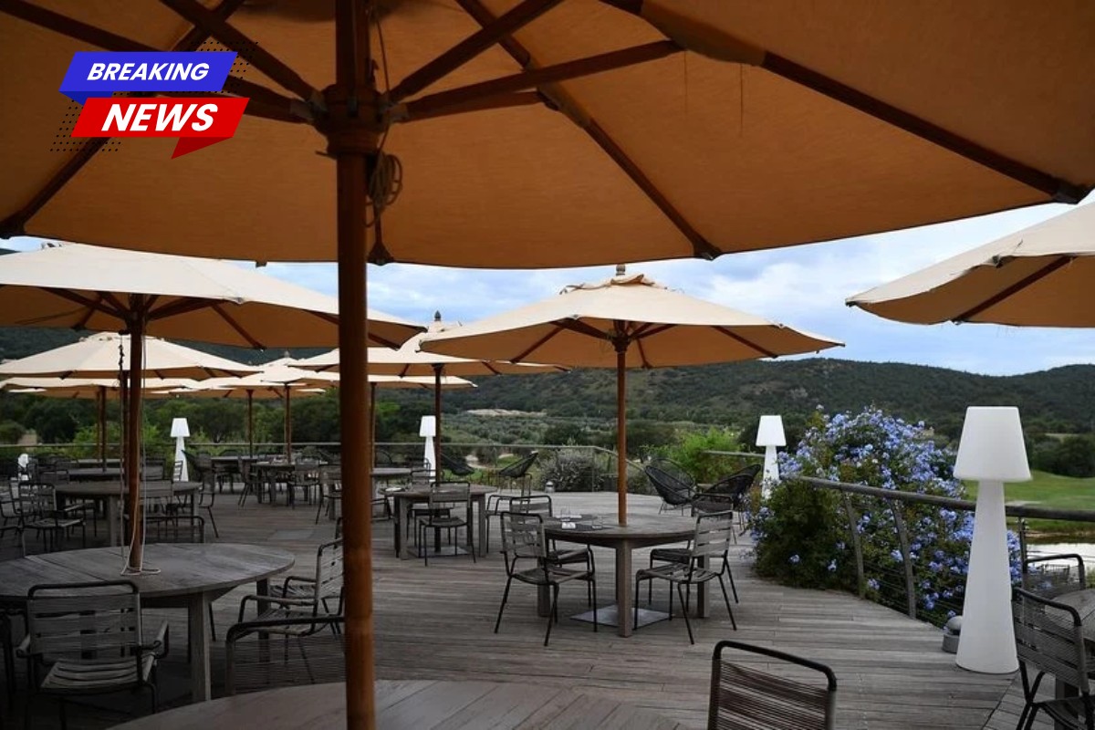 A woman was eating food in a restaurant. Then she got killed by an umbrella